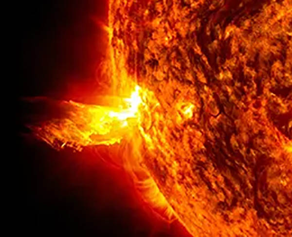 NASA spacecraft image of 
				the Sun showing both a solar flare (a bright flash of high-energy light on the Sun) and a coronal mass 
				ejection (the solar material blasting out into space). Image credit: NASA/SDO