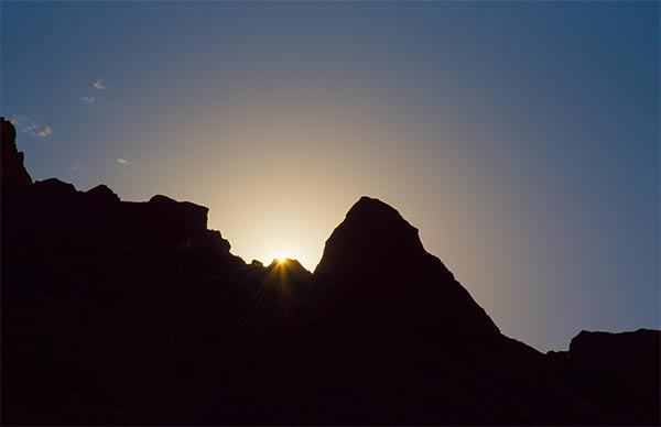 The first moment of sunrise at 
		about 7:10 am MDT on the June 2021 solstice as viewed from a spiral-like petroglyph on the northeastern facet of a Chaco 
		Sun-watching site. (credit: PUNCH Outreach photographer J. Ninnemann working with D. Johnson and C. Morrow on CHCU 
		Special Use Permit # 2102)